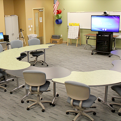 Room 1210 - half circular tables with screens