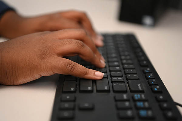 Hands typing on a keyboard