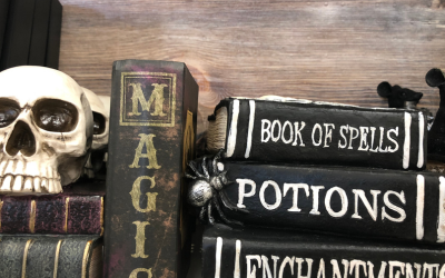 Spooky Halloween books, a skeleton head, and a spider