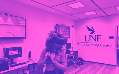 student in a virtual reality headset with UNF Virtual Learning Center sign
