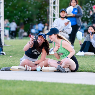 students posing for a selfie at the amphitheater