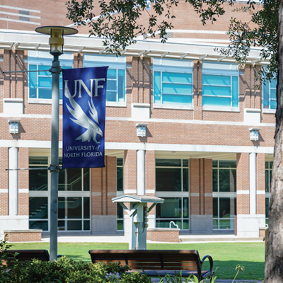 campus with UNF sign on lamppost