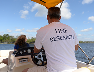 UNF Research professor steering boat