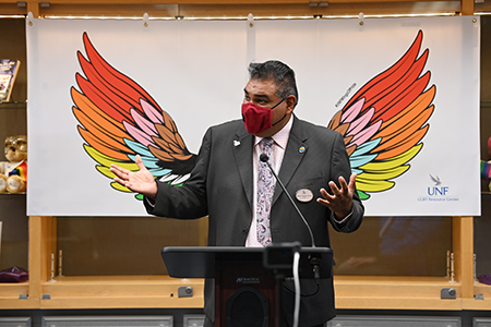 Manny Velásquez-Paredes in front of rainbow wings