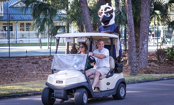 Ozzie riding on a golf cart