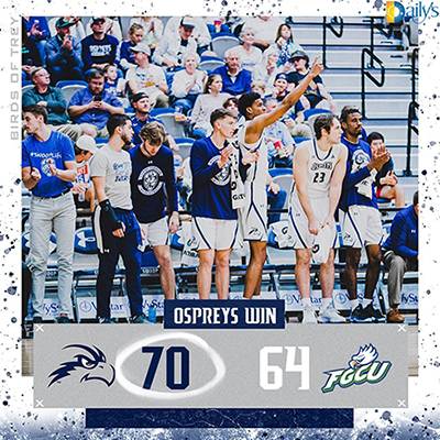Men's basketball team members celebrating a win with the score graphic below 70-64 over FGCU