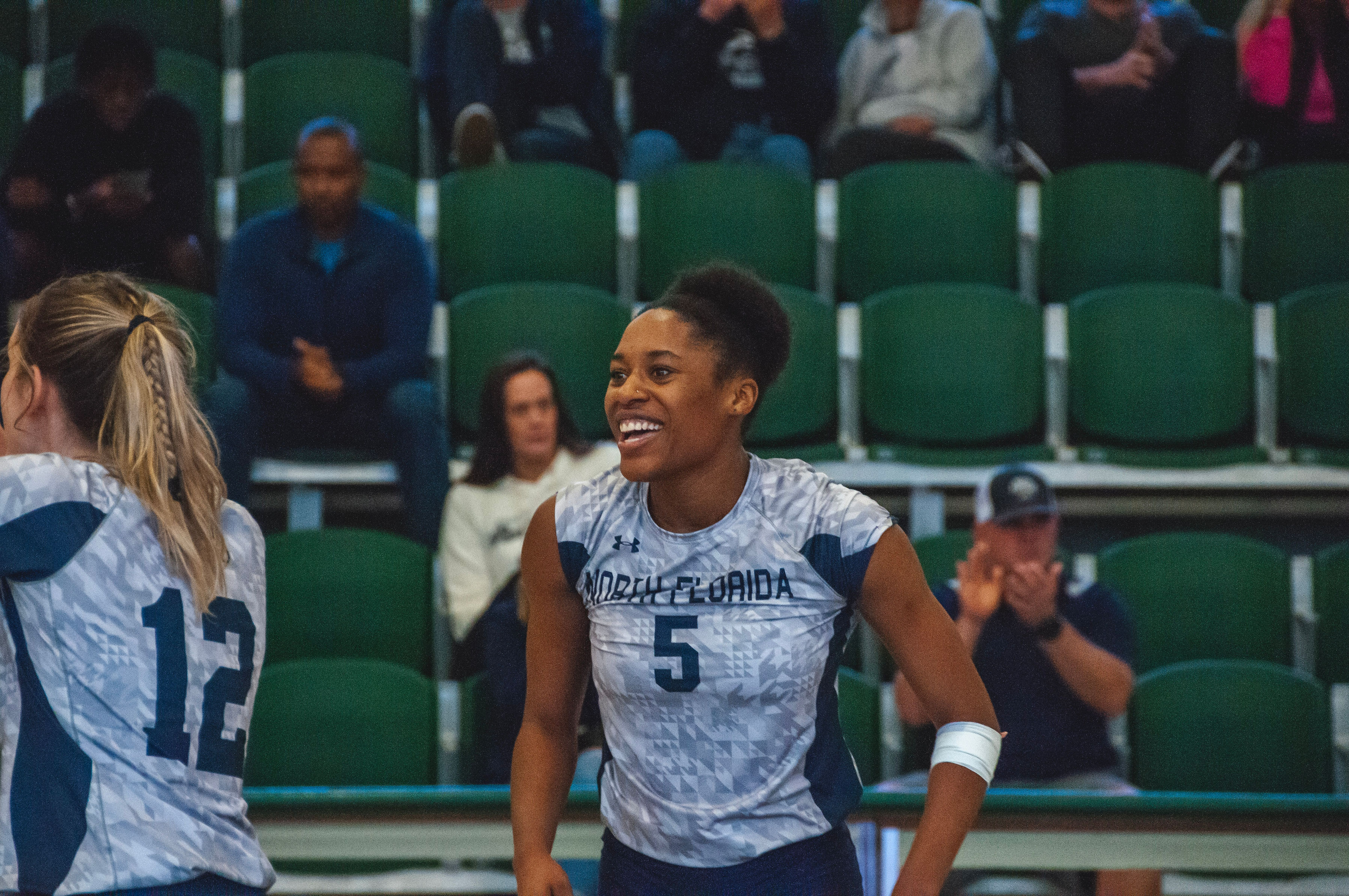 UNF volleyball player smiling on the court