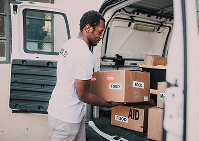 Volunteer moving boxes of food