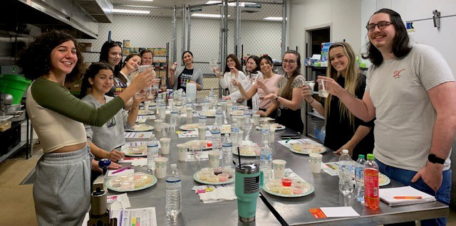 UNF students holding cups in a feeding lab