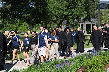 UNF students walking in the Inauguration procession