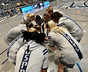 UNF women's basketball team members in a huddle