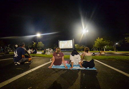 Students sitting at a drive-in movie