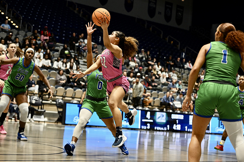 UNF women's basketball player shooting during a game