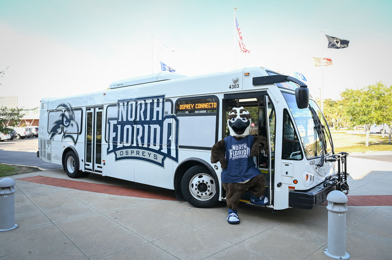 Ozzie standing next to a shuttle bus