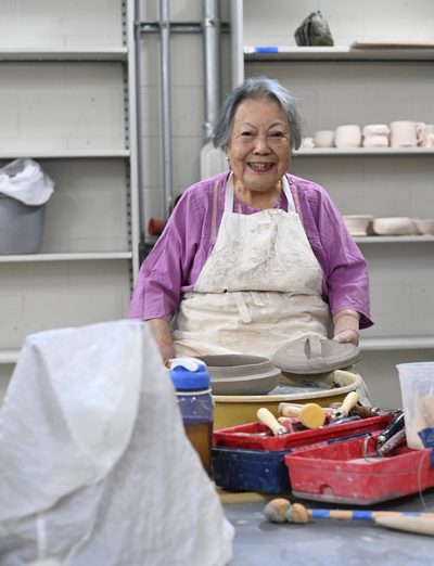 Dr Han sitting in the UNF Ceramics Lab