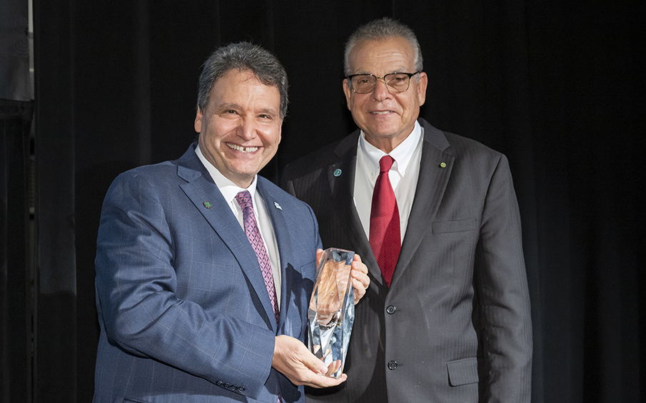 UNF President Moez Limayem accepting an award