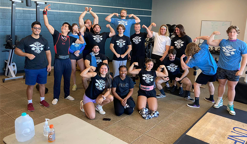 UNF students performing muscle poses