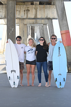UNF Surf Club members posing for photo at the beach