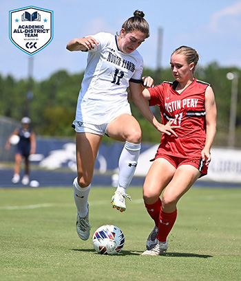 UNF soccer player kicking a ball during a game against an Austin Peay defender