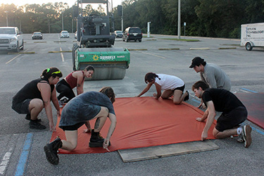 Steamroller preparing to roll over a woodblock