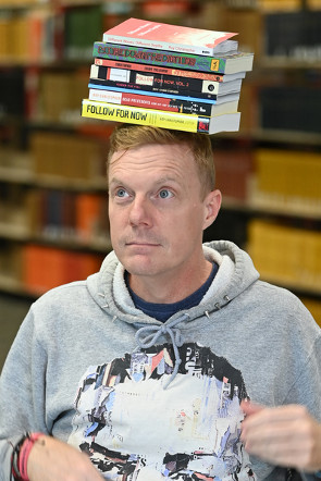 Dr. Roy Christopher balancing books on his head