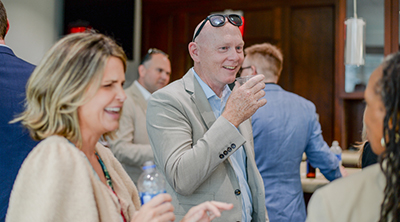 UNF faculty laughing while attending employee mixer