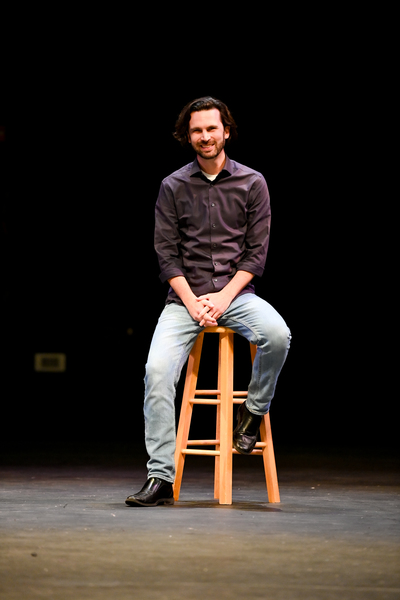 Professor WIll Pewitt sitting on a stool