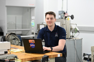 UNF student Colin Ott working on a laptop in the engineering lab