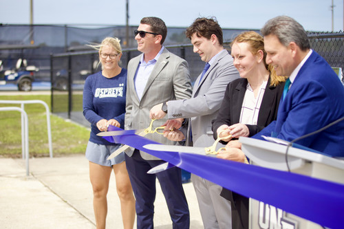 Participants in the ribbon cutting ceremony at UNF's new pickleball courts