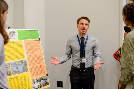 UNF student explains his research and poster at the 2024 SOARS Symposium
