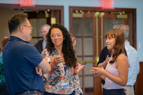 UNF faculty members conversing at a social event