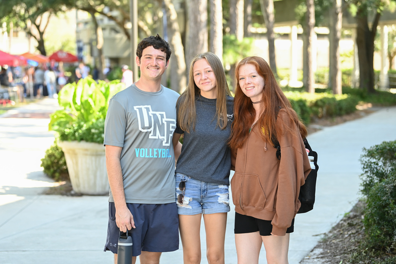 Three UNF students (1 male, 2 females) posing for a photo
