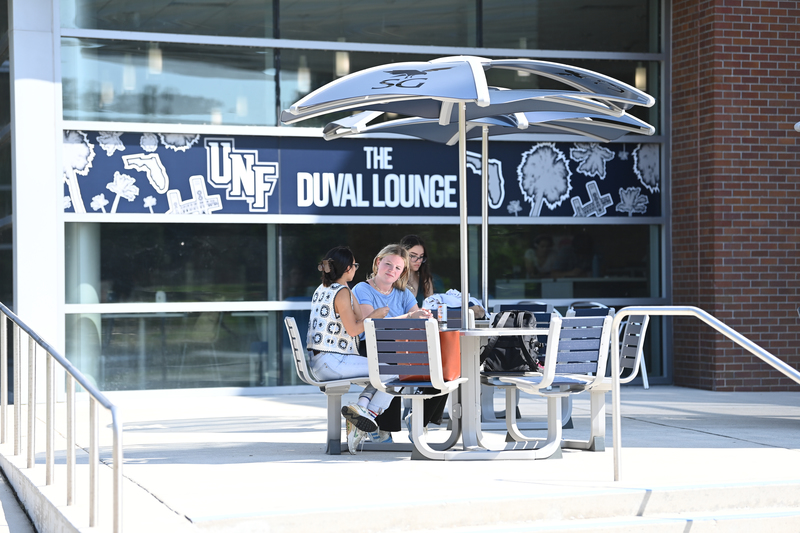 Group of UNF students gathered outside of the UNF Fine Arts Center