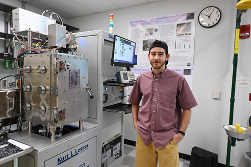 UNF alum Hudson Horne standing in a physics lab