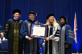 UNF leaders on stage at commencement