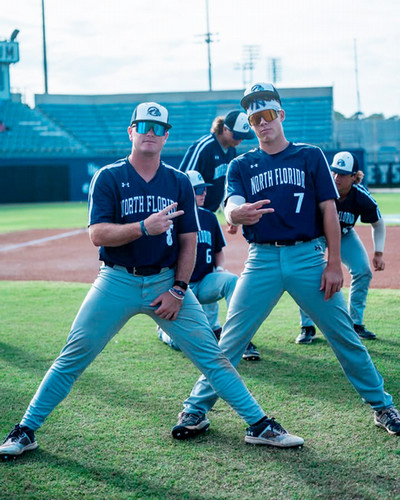 UNF baseball players gathered on the field for practice and posing for pictures
