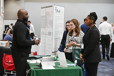 UNF students speaking with a recruiter at a career fair