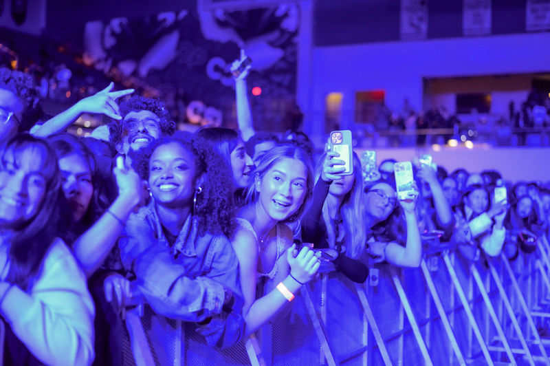 UNF students cheering and smiling at a homecoming concert