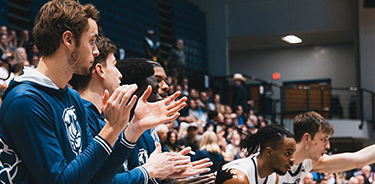 Members of UNF men's basketball cheering on the cheering