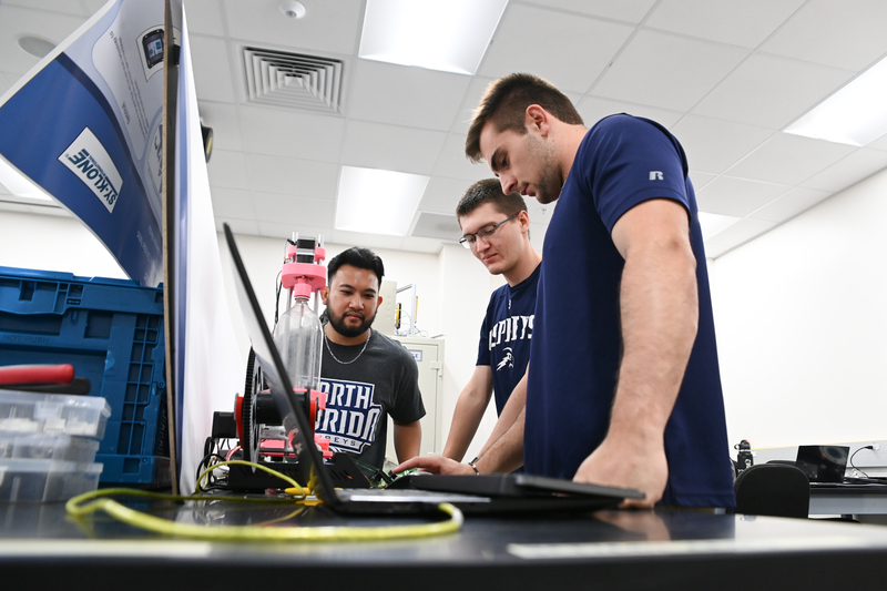 UNF engineering students working on projects in a lab