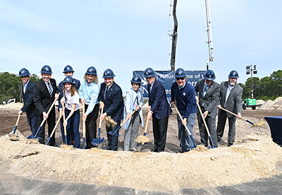 UNF and community leaders holding shovels at a groundbreaking event