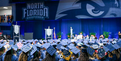 UNF in caps and gowns at graduation ceremony