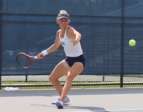 Annabelle Davis swing her tennis racket to his a ball