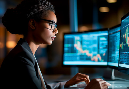 Girl working on a computer that has data on the screen