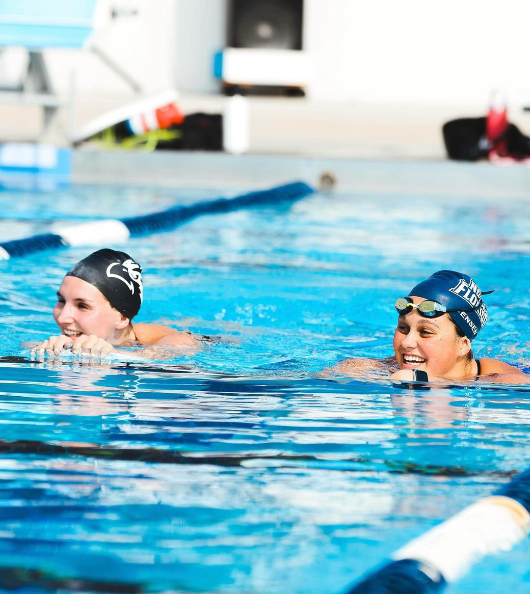 Members of the UNF women's swim team floating in the pool