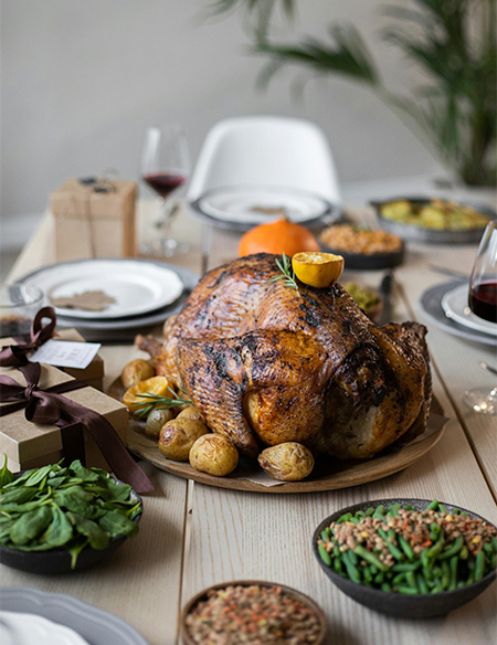 Thanksgiving dinner table with a turkey in the middle