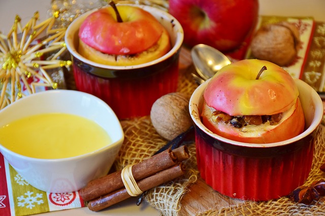 two baked apples in small individual baking dishes on a table