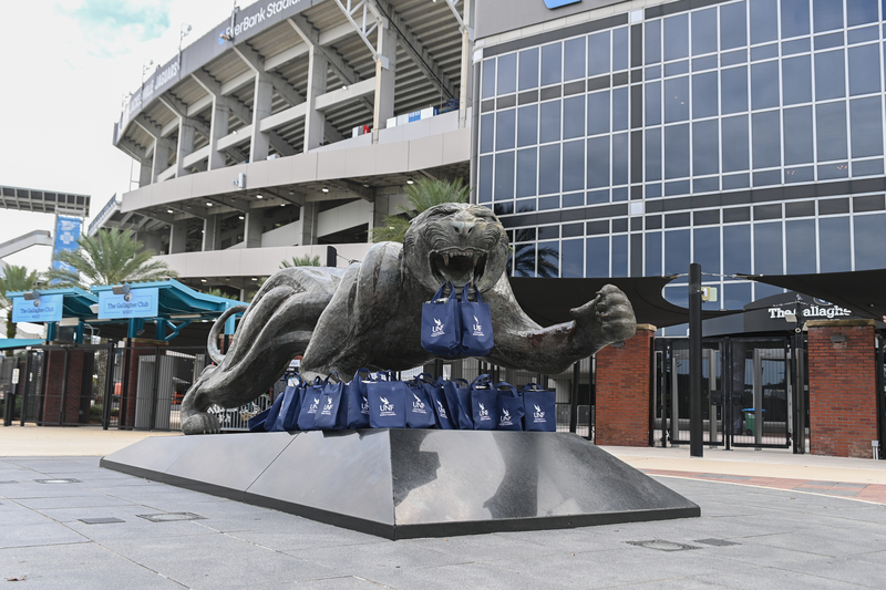 UNF swag bags positioned in front of a Jaguars statue at the Jacksonville Jaguars stadium 