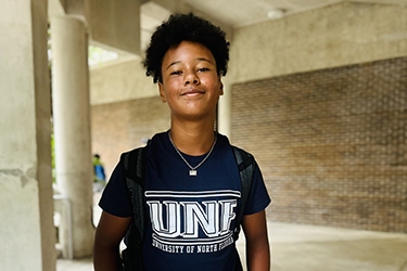 UNF student Cameron Robinson standing outside of a classroom