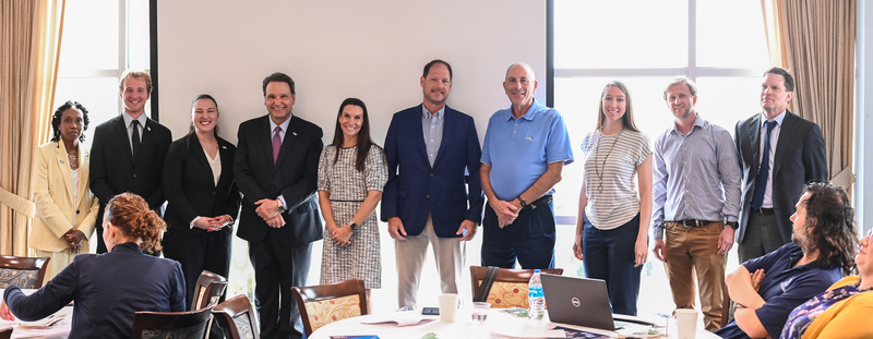 UNF faculty and University leadership posing together at an event